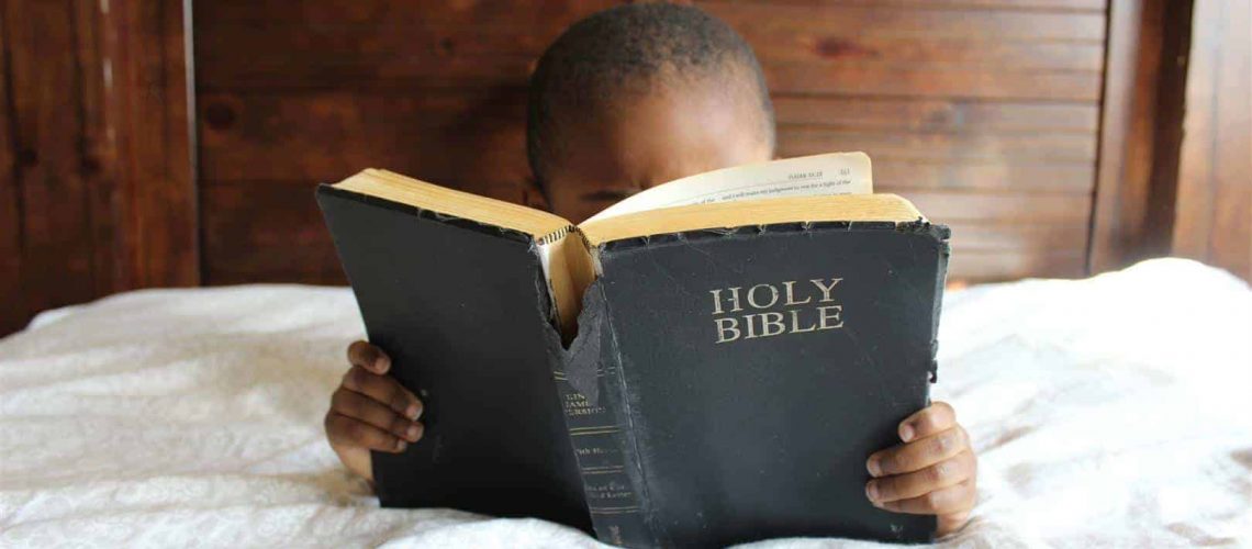 Kid reading the Bible